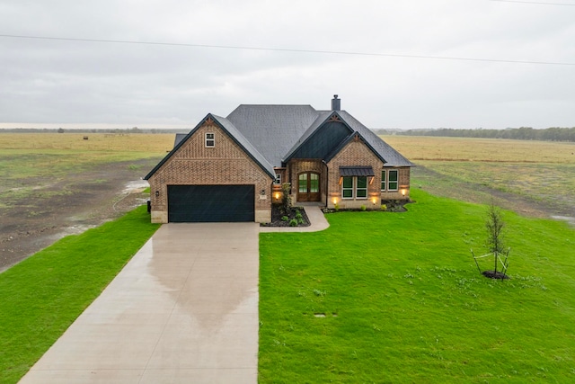 view of front of house with a garage and a front lawn