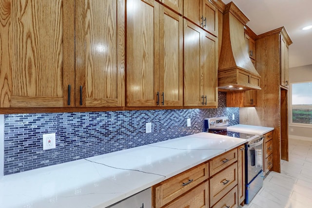 kitchen with light stone counters, electric stove, decorative backsplash, light tile patterned floors, and custom exhaust hood