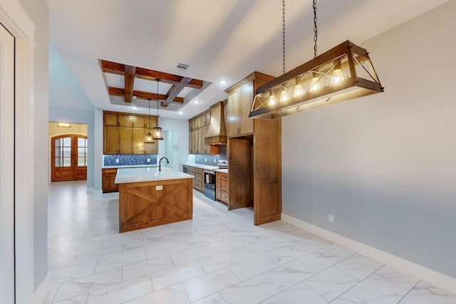 kitchen with premium range hood, stainless steel range with electric stovetop, a center island with sink, beam ceiling, and hanging light fixtures