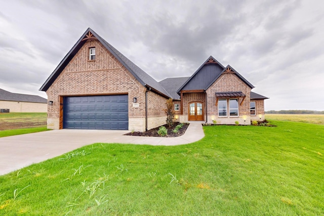 view of front of house with a front yard and a garage