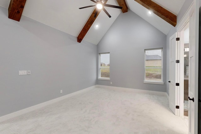 carpeted empty room featuring high vaulted ceiling, ceiling fan, a healthy amount of sunlight, and beam ceiling