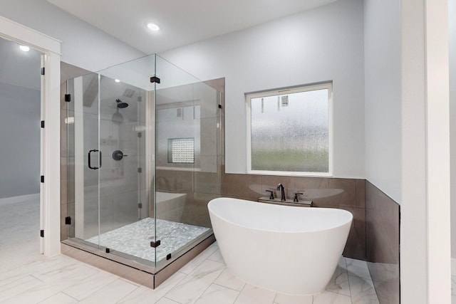 bathroom featuring separate shower and tub