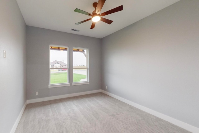 empty room with light colored carpet and ceiling fan