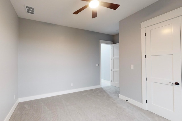 unfurnished bedroom featuring ceiling fan and light carpet