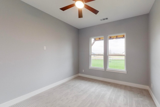 carpeted empty room featuring ceiling fan