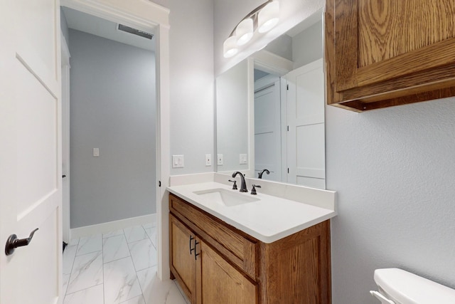 bathroom with toilet and vanity