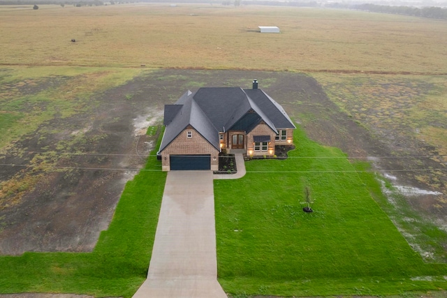 birds eye view of property with a rural view