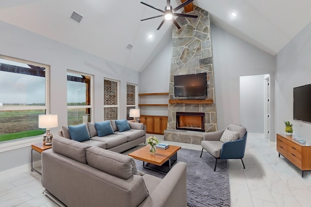 living room with a fireplace, ceiling fan, and high vaulted ceiling