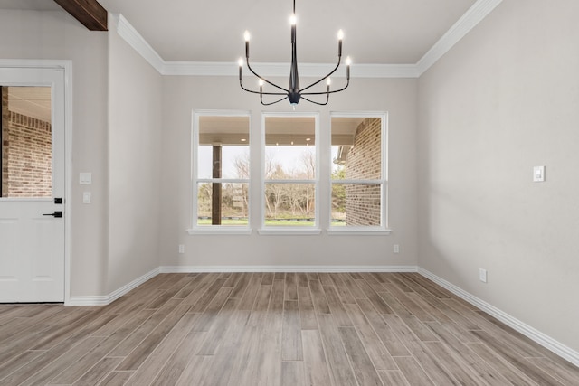 unfurnished dining area featuring a notable chandelier, baseboards, wood finish floors, and ornamental molding