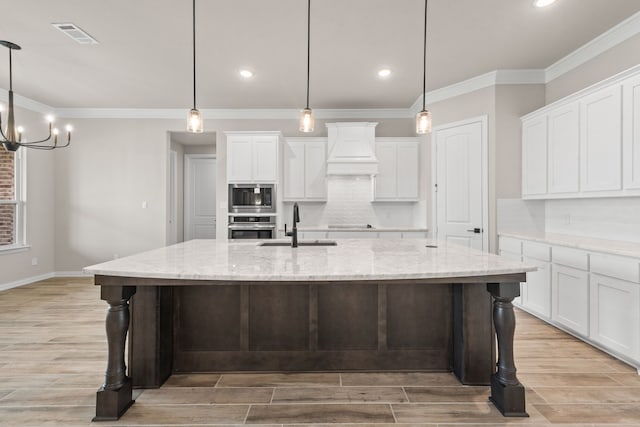kitchen featuring wood tiled floor, premium range hood, appliances with stainless steel finishes, white cabinetry, and a sink