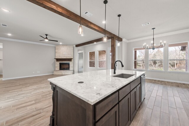 kitchen featuring a sink, visible vents, dishwasher, and beamed ceiling