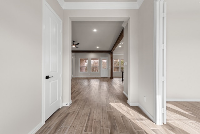 hallway featuring crown molding, light wood-style flooring, recessed lighting, and baseboards