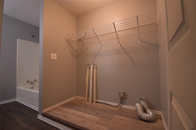 laundry room with electric dryer hookup and hardwood / wood-style floors