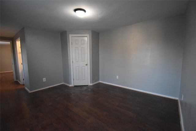 unfurnished room with dark hardwood / wood-style floors