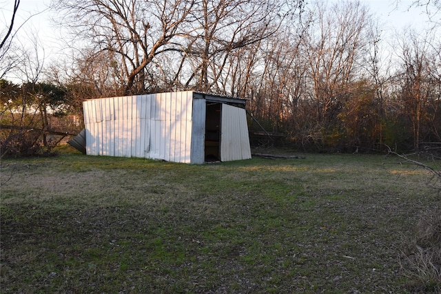 view of outbuilding with a lawn