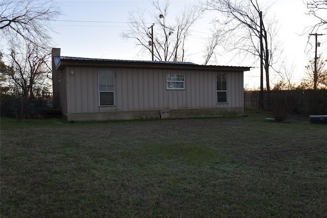 property exterior at dusk with a yard