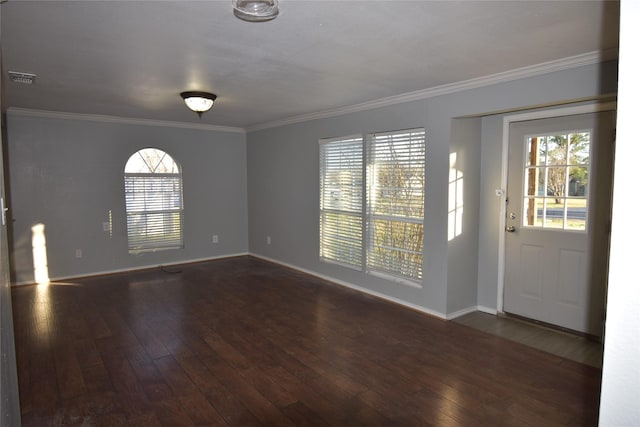 foyer entrance with dark hardwood / wood-style flooring and crown molding