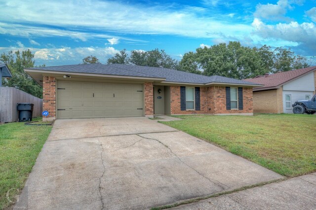 ranch-style home with a front lawn and a garage