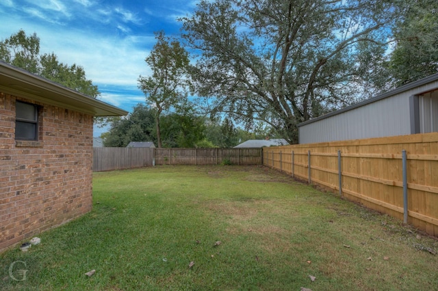 view of yard featuring a fenced backyard