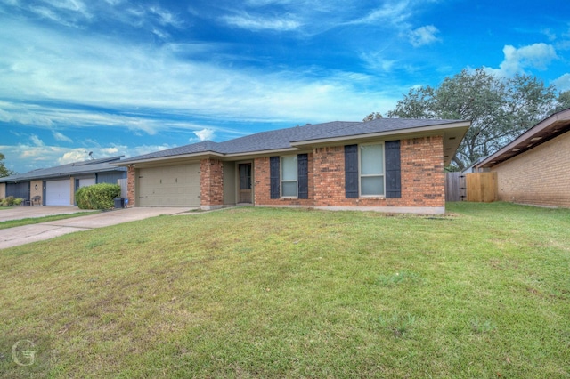 ranch-style house with driveway, brick siding, an attached garage, fence, and a front yard