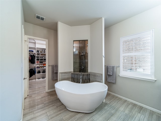 bathroom with separate shower and tub