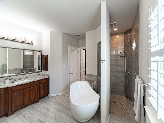 bathroom featuring vanity and plus walk in shower