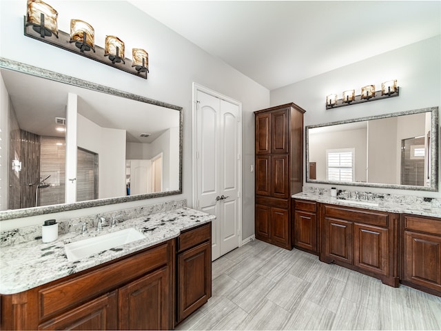 bathroom featuring a shower and vanity