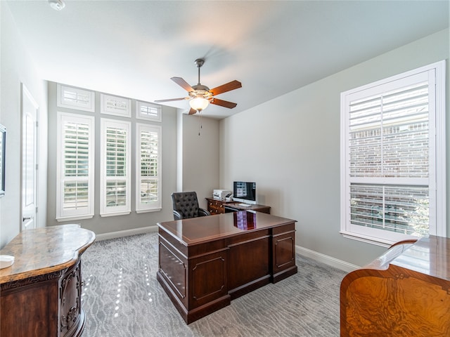 office space with ceiling fan and light carpet