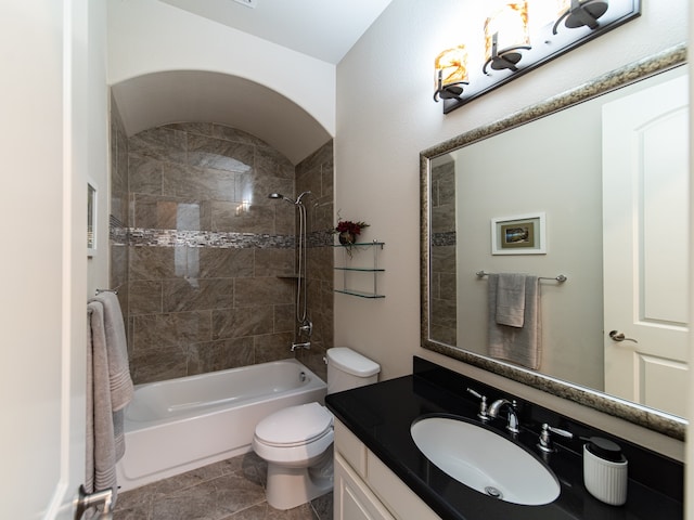 full bathroom with tile patterned flooring, tiled shower / bath combo, toilet, and vanity