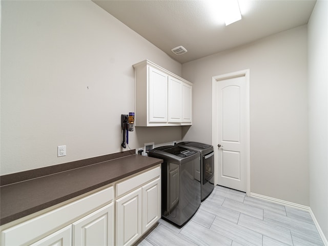 laundry area with cabinets and washer and dryer