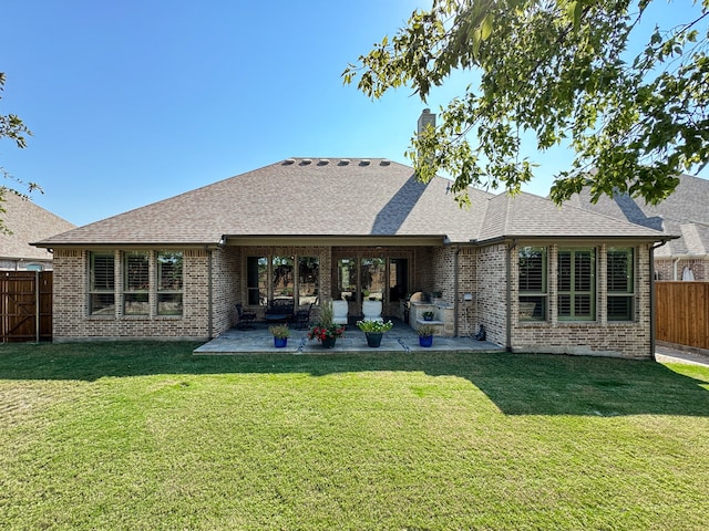 back of house with a patio area and a yard