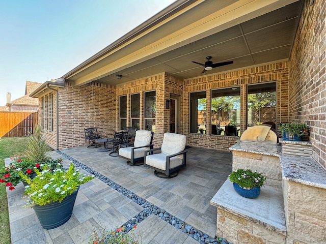 view of patio featuring area for grilling and ceiling fan