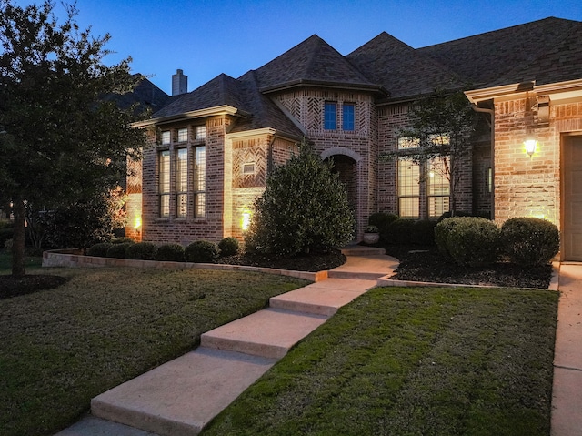 french country home featuring a lawn