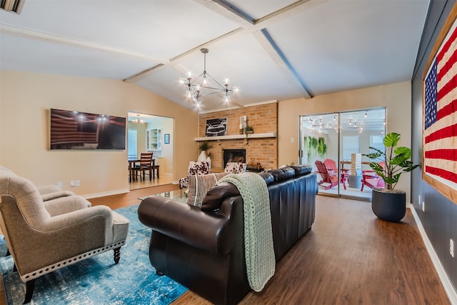 living room with an inviting chandelier, wood-type flooring, a fireplace, and vaulted ceiling