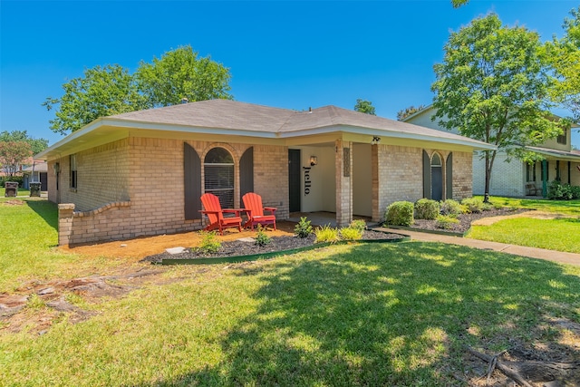 ranch-style home with covered porch and a front lawn