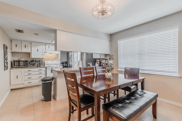 tiled dining space featuring sink