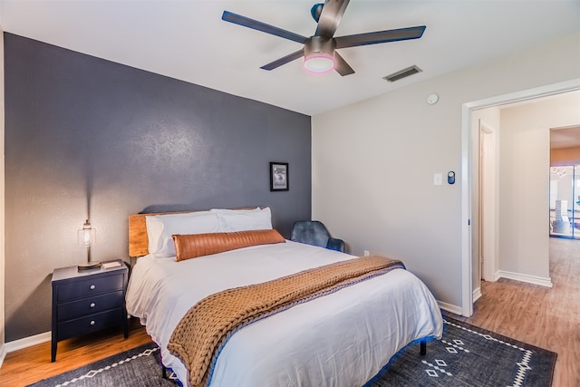 bedroom with hardwood / wood-style floors and ceiling fan