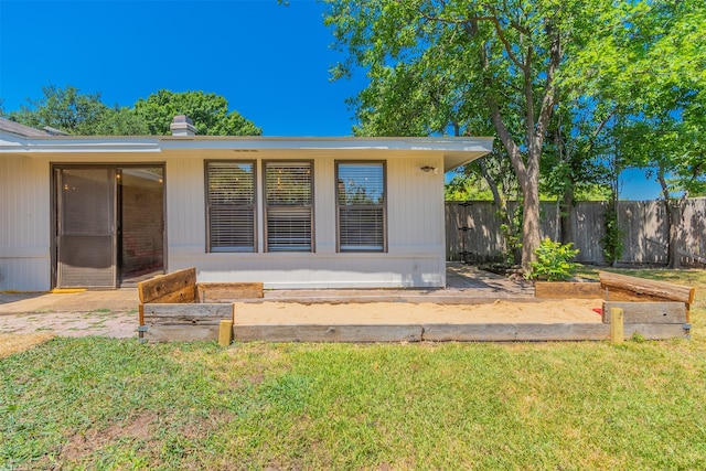 back of property featuring a yard and a patio area