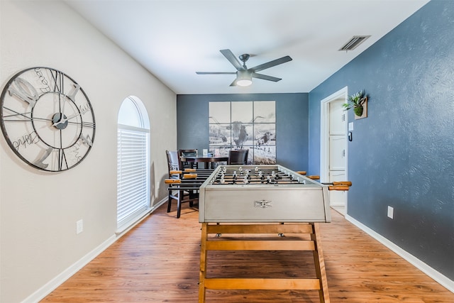 game room with light hardwood / wood-style floors and ceiling fan