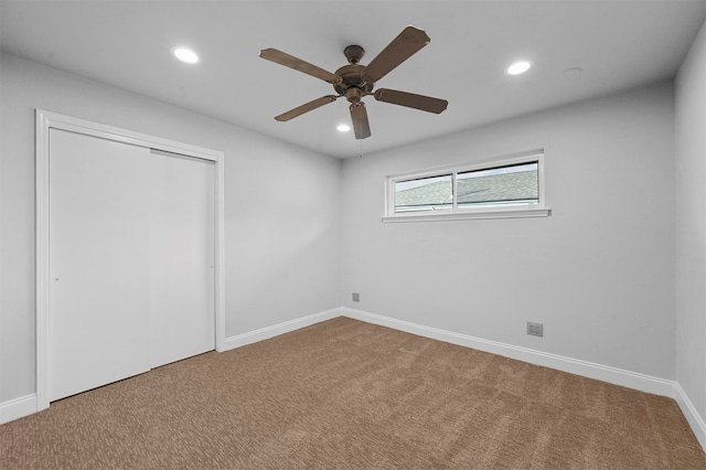 unfurnished bedroom featuring a closet, carpet flooring, and ceiling fan