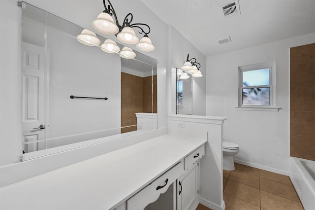 bathroom featuring vanity, toilet, and tile patterned flooring