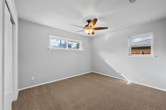 unfurnished bedroom with a closet, ceiling fan, carpet, and multiple windows