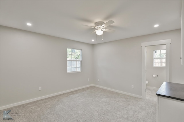 carpeted empty room featuring ceiling fan