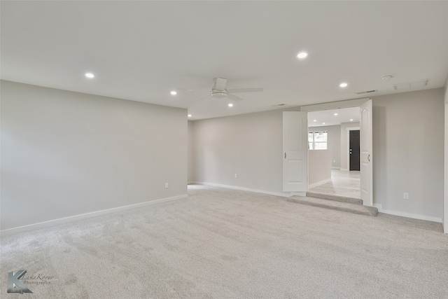 carpeted spare room with ceiling fan