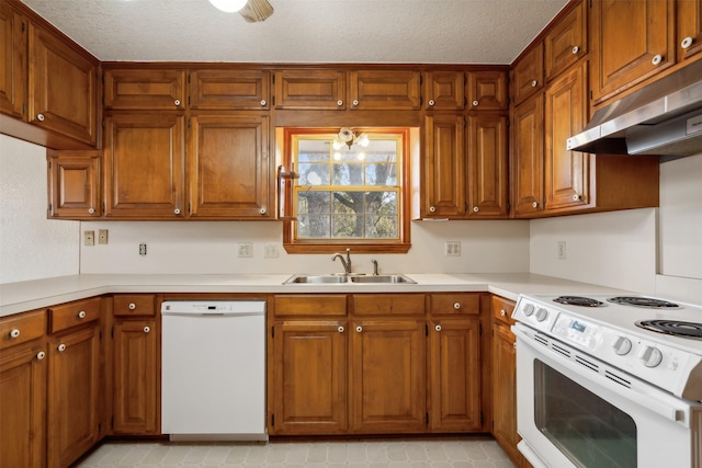 kitchen featuring a textured ceiling, sink, white appliances, and an inviting chandelier