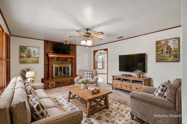 living room with a fireplace, ceiling fan, and crown molding