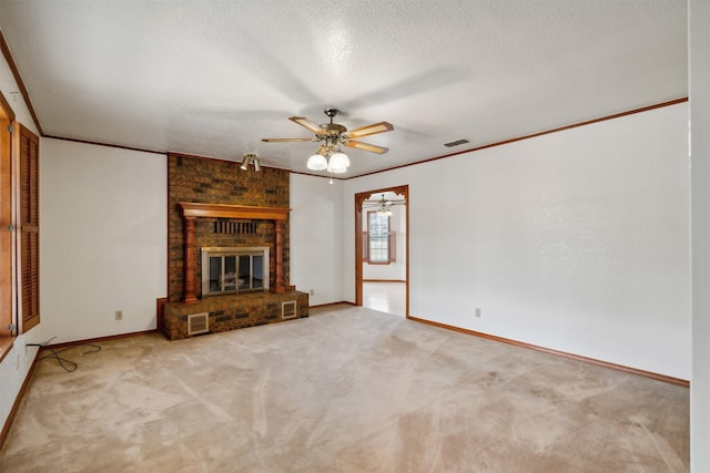 unfurnished living room with a brick fireplace, ceiling fan, ornamental molding, a textured ceiling, and carpet floors