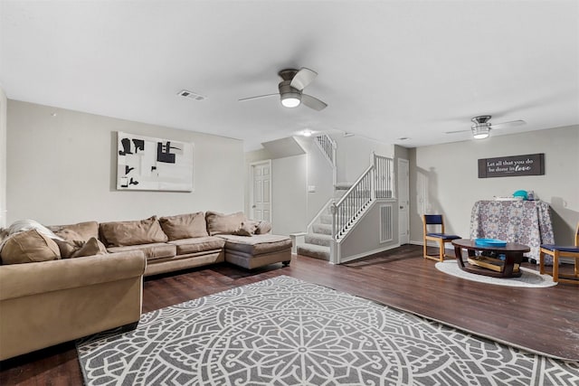 living room featuring dark wood-type flooring and ceiling fan