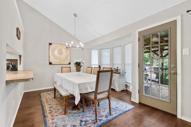 dining space with dark hardwood / wood-style flooring, a notable chandelier, and plenty of natural light