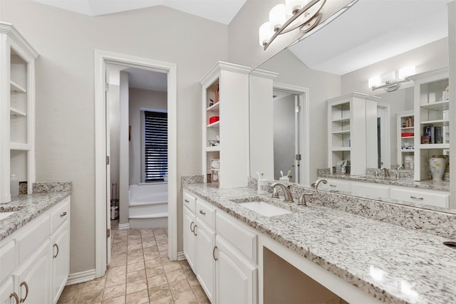 bathroom with vanity and lofted ceiling